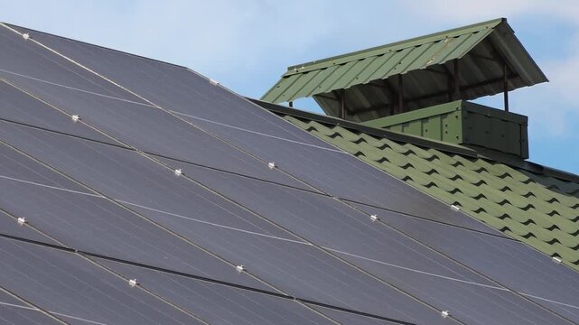 Solar panels installed on the roof of a city building. Concept of eco friendly and alternative power source. 