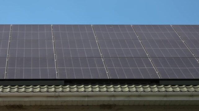 Solar panels installed on the roof of a city building. Concept of eco friendly and alternative power source. 