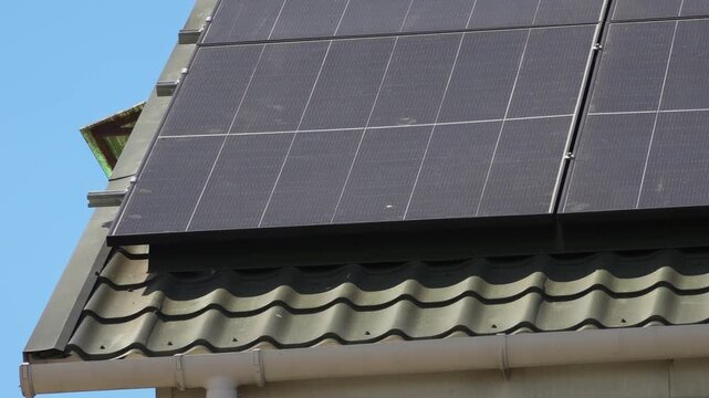 Solar panels installed on the roof of a city building. Concept of eco friendly and alternative power source. 