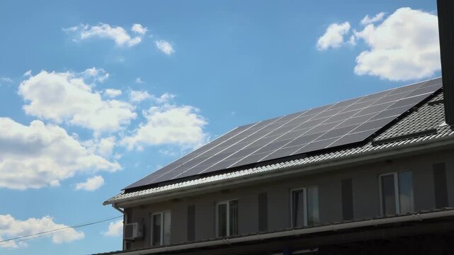 Solar panels installed on the roof of a city building. Concept of eco friendly and alternative power source. 