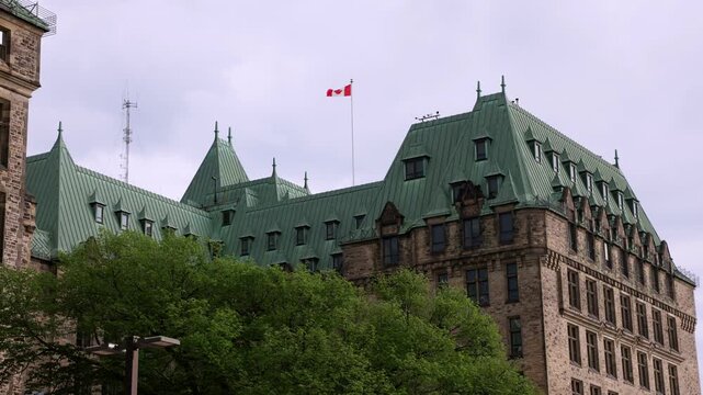 Confederation Building chateau style architecture and Canadian flag.