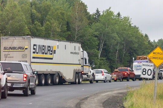 Quebec, Canada, 30 July 2026 : A Sunbury semi truck and other vehicles move slowly in a line of traffic on a highway.