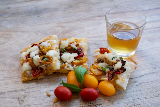 Italian focaccia pizza with glass of white wine