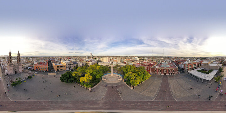 Aerial view of the historic Plaza de la Patria with its central Exedra monument, surrounding colonial architecture, and the Cathedral of Aguascalientes in Aguascalientes, Aguascalientes, Mexico.
