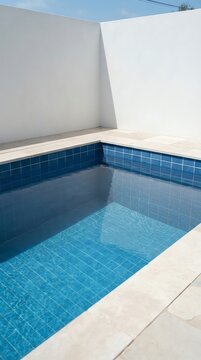 Modern Swimming Pool with Blue Tiles and White Walls.
