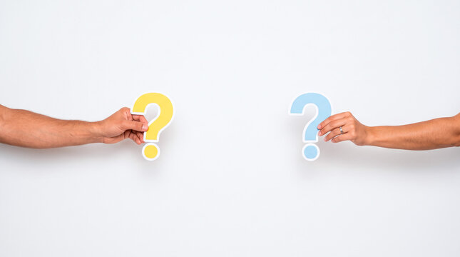 Two hands hold colorful question marks against a white background, symbolizing inquiry