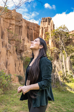 Woman Looking Up near Eroded Clay Cliff and Hoodoos. Tatacoita - Nemocon