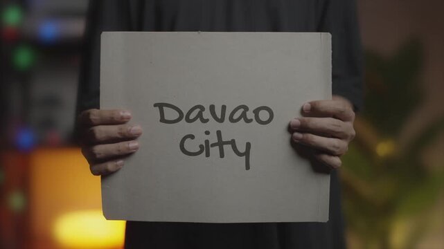 Davao City written on Banner &ndash; Man Holding Placard