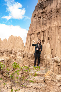 Woman Waving Standing Beside Eroded Clay Rock Formations. Tatacoita - Nemocon