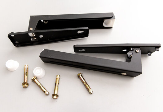 Foldable Black Metal Brackets and Wall Anchors on White Background