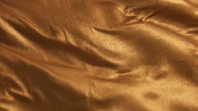 Flowing Golden Satin Fabric Background Moving in Gentle Waves