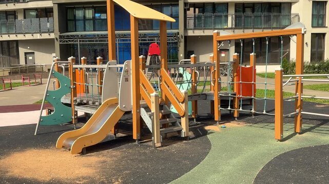 Outdoor playground with colorful slides and obstacle equipment, family recreation, active childhood, public leisure, summer play area.