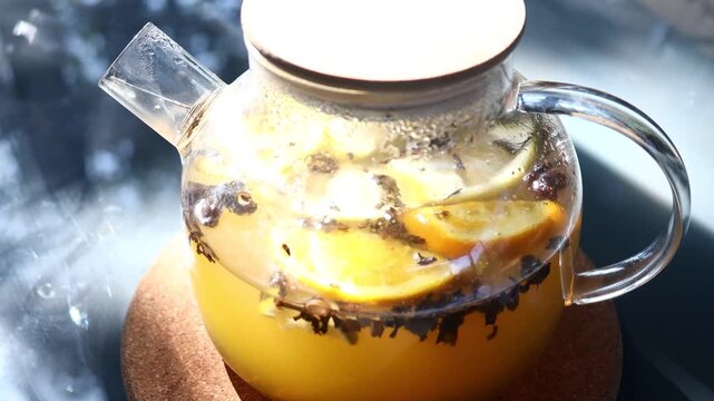 A clear glass pitcher filled with refreshing lemon slices and water, perfect for a healthy drink or garnish