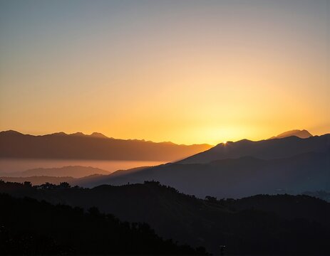 the sun is setting over the mountains