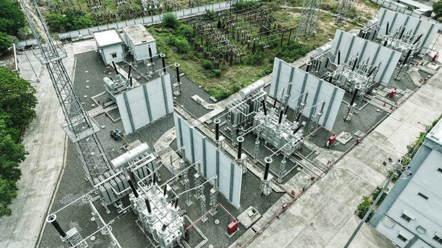 Aerial view of the electrical substation in Tharamani featuring high-voltage transformers, metal structures, and concrete barriers within an industrial site in Chennai, Tamil Nadu, India.