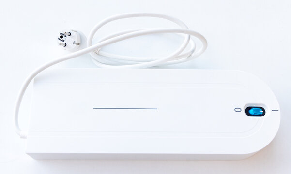White Electronic Device with European Plug and Blue Power Switch