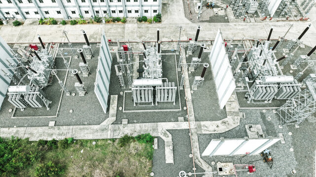 Aerial view of the electrical substation in Tharamani featuring high-voltage transformers and industrial equipment set on gravel grounds in Chennai, Tamil Nadu, India.