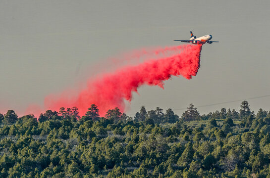10 Tanker DC-10 Jet Dropping Red Fire Retardant Slurry on Forest Wildfire