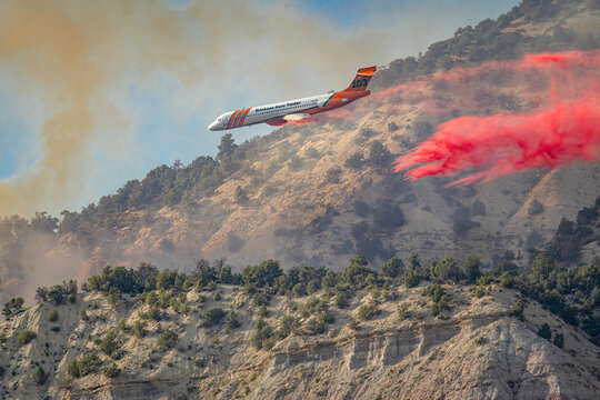 Erickson Aero Tanker MD-87 Jet Dropping Red Fire Retardant on Mountain Wildfire