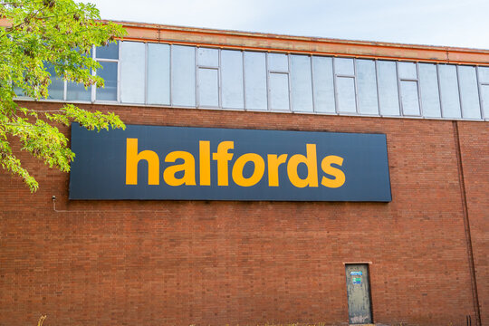 Redditch, Worcestershire, UK - August 14 2026: External building signage of Halfords at a warehousing and logistics location