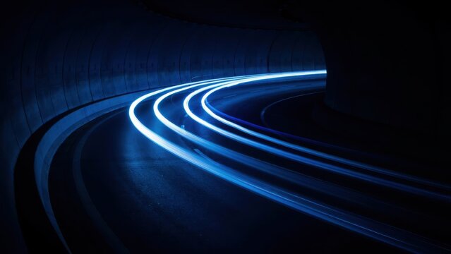 Blue light trails in dark tunnel curve representing high speed data transfer and futuristic transportation.