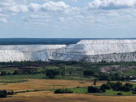 Aerial view of the industrial phosphogypsum stacks of UAB Imlitex surrounded by agricultural fields and green forests in Kedainiai, Kauno apskritis, Lithuania.