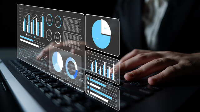 A professional interacts with a laptop displaying holographic data visualization, showcasing various charts and graphs in a modern office setting, highlighting business analytics trends. Gantry