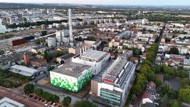 Aerial view of Keppel Data Center Reit in an industrial area with modern buildings, rooftops, and green trees in Offenbach am Main, Hessen, Germany.