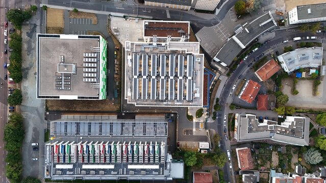 Aerial view of the Keppel Data Center Reit facility featuring industrial buildings with rooftop cooling units and solar panels in the urban landscape of Offenbach am Main, Hessen, Germany.