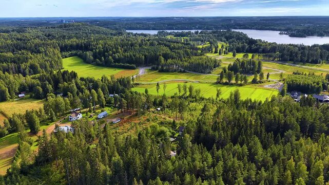 Idyllic countryside living neighbourhood with fields and modern homes aerial drone video