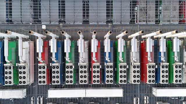 Aerial view of the Keppel Data Center Reit facility featuring rows of colorful industrial cooling units and ventilation systems on the rooftop in Offenbach am Main, Hessen, Germany.