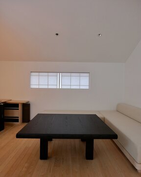 Minimalist Living Room with Dark Wood Coffee Table and White Sofa