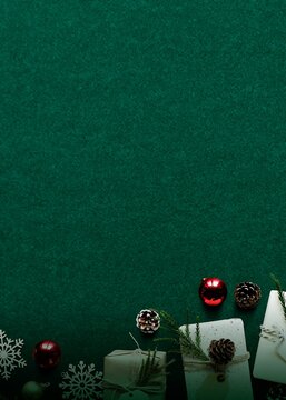 Festive Christmas background with ornaments, gifts, and pinecones.