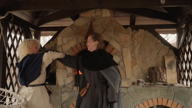 Monks preparing food in a communal kitchen, in a medieval-style kitchen with stone ovens and wooden, with stone ovens, wooden beams, fire, from a side view capturing the monks actions perspective.