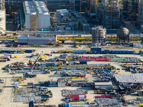 Aerial view of the Zakladowa Straz Pozarna PKN Orlen industrial facility featuring storage tanks, construction equipment, and material stockpiles in Plock, Masovian Voivodeship, Poland.
