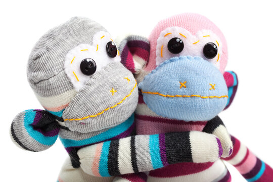 Monkey sock toys isolated on white background. Giving a hug