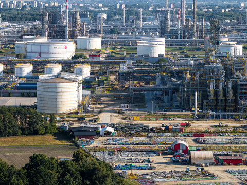 Aerial view of PKN Orlen refinery featuring large storage tanks, complex industrial piping, and processing facilities in Plock, Masovian Voivodeship, Poland.