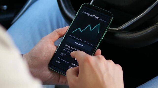 Person reviews weekly step statistics and activity trends on a smartphone, reflecting the growing role of digital wellness, self-tracking and everyday fitness monitoring.