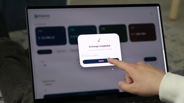 Person confirms a digital currency exchange on a laptop, capturing secure financial technology, borderless transactions and changing consumer banking habits.