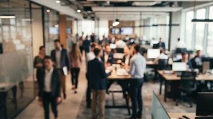 Fototapeta premium Blurred busy modern corporate office with workers and meetings