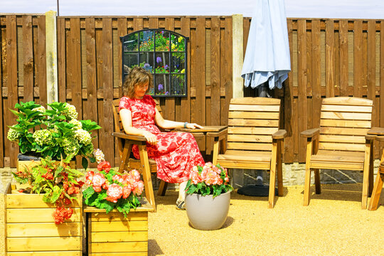 Lady in red, in August, 2026 sunlight.