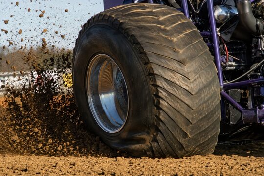 Pulling Tire Under Torque Tractor Pulling Scene