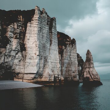 Dramatic sea stack cliffs at sunset with boat.