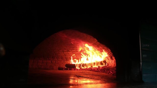Slow motion fire burning inside stone oven