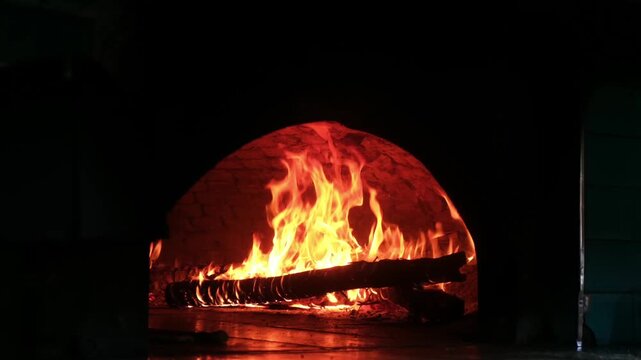 Removing freshly baked meat flatbread from stone oven