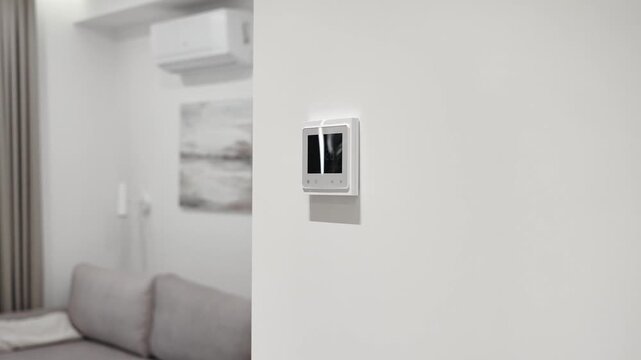white thermostat for underfloor heating and climate control systems. control panel. apartment, house, hotel. smart home. automatic heating system. technology. stylish designer expensive repair