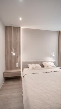 elegant white and beige bedroom in a modern apartment. luxury hotel room. interior design, new renovation. bright apartment, lots of light, beige soft bed, curtains, light walls