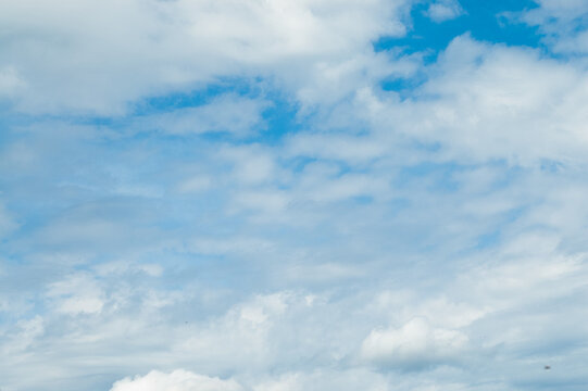 The photo shows a blue sky and clouds
