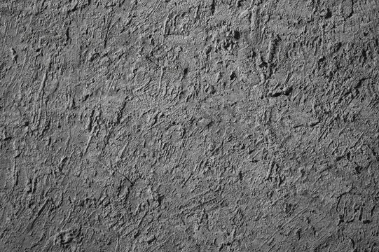 Gray background, photo of the texture of an old wall with various lines, embossing, and brushstrokes