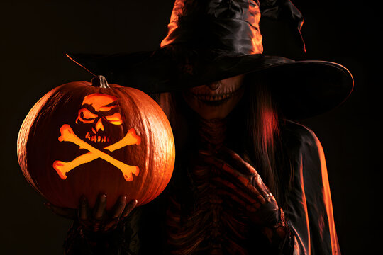 monster skulls and crossbones, along with a halloween witch and a pumpkin, create a spooky and scary atmosphere during the halloween season
